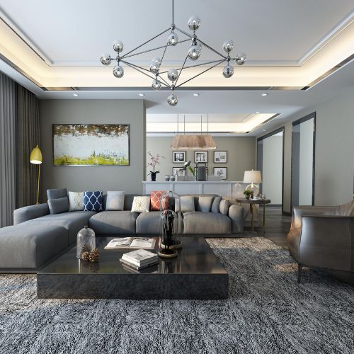 A modern living room featuring a gray comfortable couch and a metal chandelier.